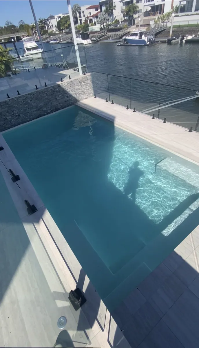 Crystal-clear waterfront pool serviced by Deep Blue on the Gold Coast