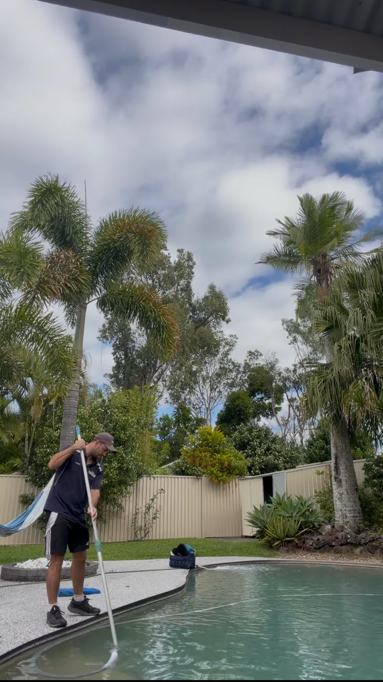 Jordan from Deep Blue vacuuming a pool on the Gold Coast